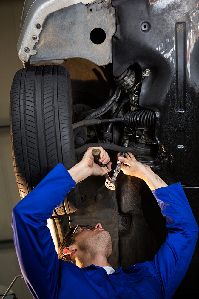mechanic doing preventative maintenance on a car