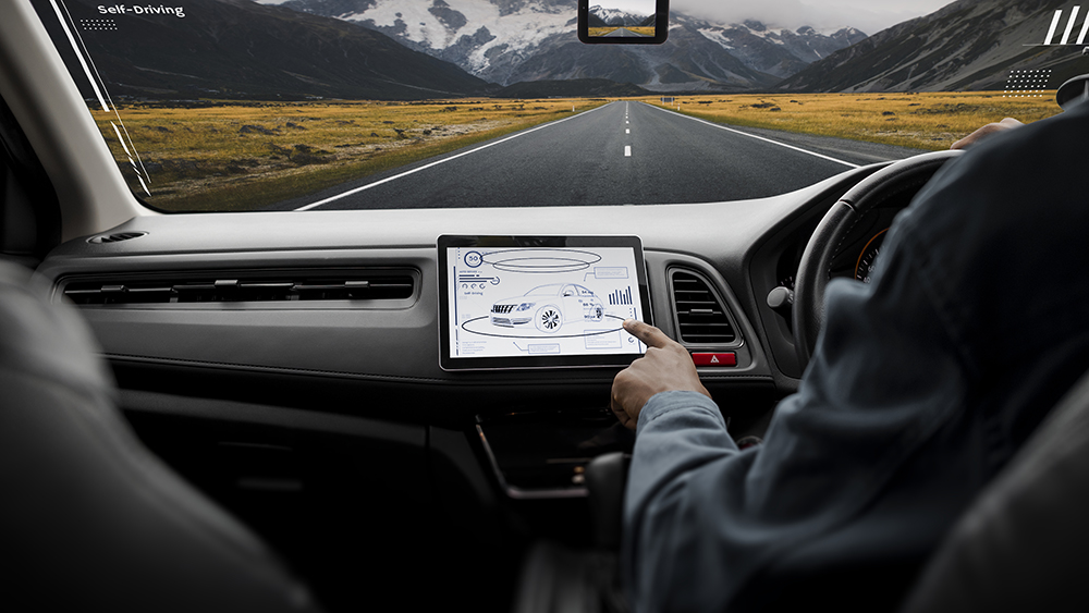 driver on the road looking at ADAS system on screen