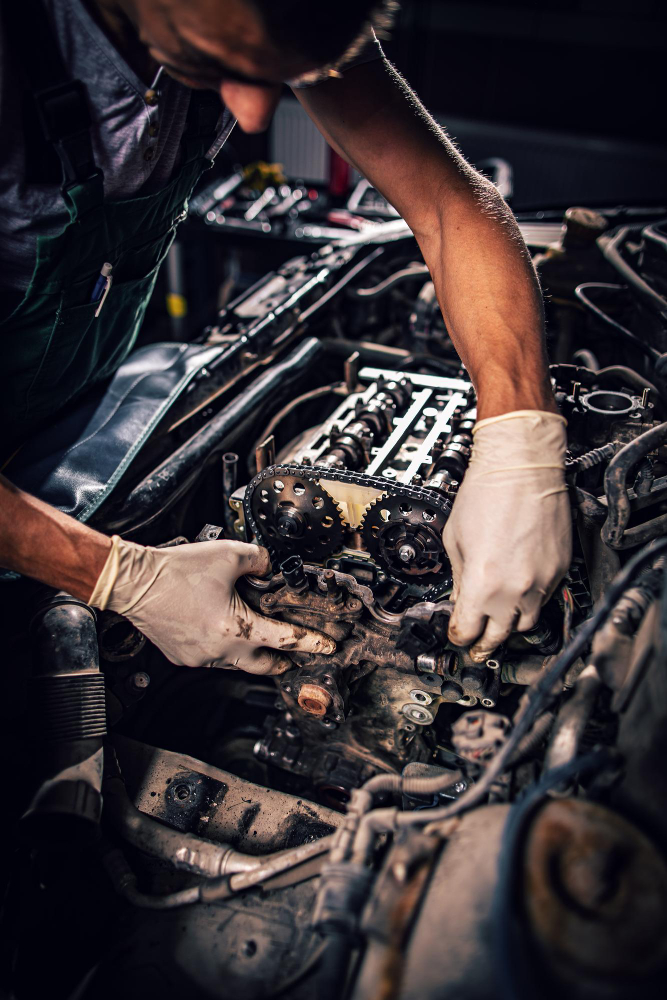 closeup of a mechanic working on a vehicle for transmission engine service